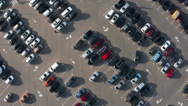 Top view car Parking on parking place. Aerial view from Drone many Cars Moving and standing on parking. Car traffic and Parking Concept.