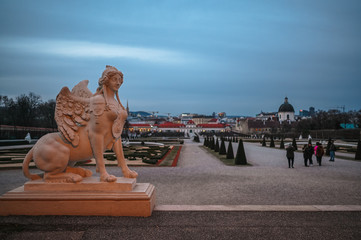 Sphinx sculpture in the garden of Belvedere in Vienna, Austria, with the lower Belvedere palace and...