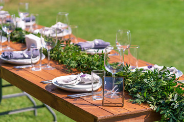 Preparing for an open-air party. Decorated with fresh flowers served tables. Table number. Decoration Details