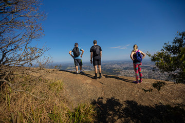 Hiker with backpack crossing rocky terrain in Pedra Grande Atibaia São Paulo Brazil