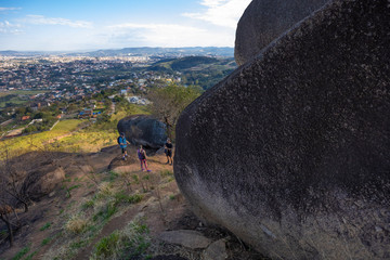 Hiker with backpack crossing rocky terrain in Pedra Grande Atibaia São Paulo Brazil