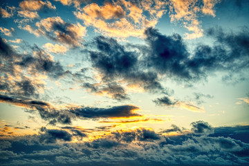 Dramatic dark orange, black, yellow and red sunrise sky after raining natural beautiful sky for background.