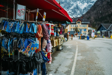 Souvenir shop with traditional postcards, magnets, bags, scarves, socks at the historic area of the mountain village Hallstatt. Austria. Unesco. Salzkammergut region. Travel and touristic concept