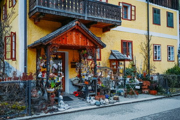 Fototapeta na wymiar Souvenir shop at the historic area of the mountain village Hallstatt with traditional colorful wooden houses in Halshtati. Austria. Unesco. Salzkammergut region.