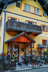 Fototapeta na wymiar Souvenir shop at the historic area of the mountain village Hallstatt with traditional colorful wooden houses in Halshtati. Austria. Unesco. Salzkammergut region.