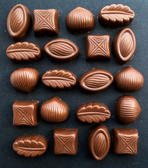 Assortment of chocolates, white, dark and milk chocolate sweets background. Space for copy. View from above.