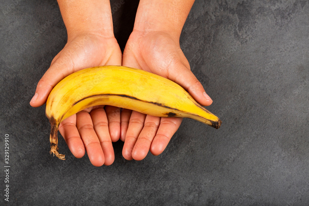 Canvas Prints Musa x paradisiaca - Hands holding a ripe banana