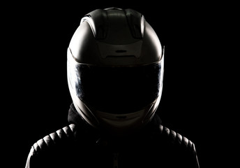 silhouette of a motorcyclist in a helmet and leather jacket
