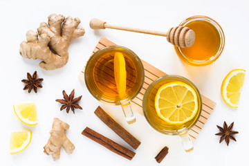 Tea with ginger, honey, lemon, cinnamon, anise on white background. Isolated. Flat lay, top view