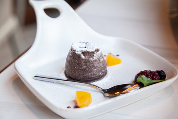Warm dark chocolate lava cake on white plate