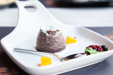 Warm dark chocolate lava cake on white plate