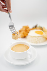 Buttermilk chicken rice with ingredients isolated on white with fried egg and salad. Chicken dumb into buttermilk sauce.