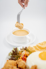 Buttermilk chicken rice with ingredients isolated on white with fried egg and salad. Chicken dumb into buttermilk sauce.