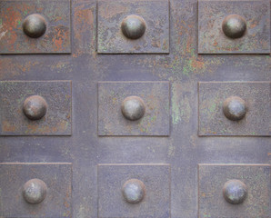 rusty iron plate with rectangular designs and studs in relief.texture background