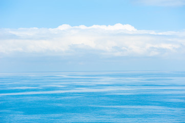 Obraz na płótnie Canvas Blue sea background. Beautiful seascape and the blue sky with clouds. Travel destination concept
