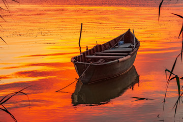 Beautiful morning landscape with a boat on the lake at the sunrise, Razelm Lake, Sarichioi, Romania