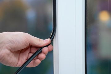 Professional master at repair and installation of windows, changes rubber seal gasket in pvc windows