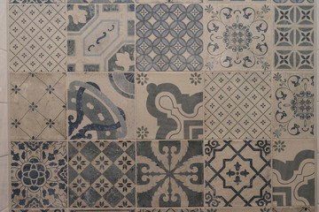 Decorative blue and cream tiles with different patterns on a wall