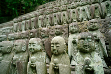 Obraz premium Stone dolls face smile are Jizo Bodhisattva, who takes the spirit of children to heaven at Hasedera Temple, Kamakura 