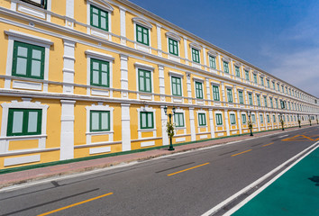 Empty Road beside window and wall of Thai Ministry of Defence building, yellow wall,one of Thailand landmark