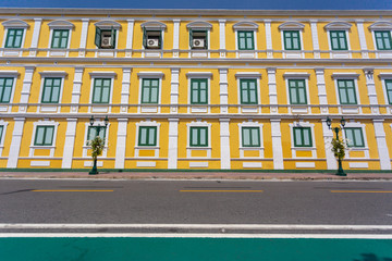 Fototapeta na wymiar Beautiful windows and yellow walls of Thai Ministry of Defence building,one of Thailand landmark