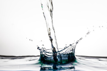 Pouring water splash on water surface on white background, isolated