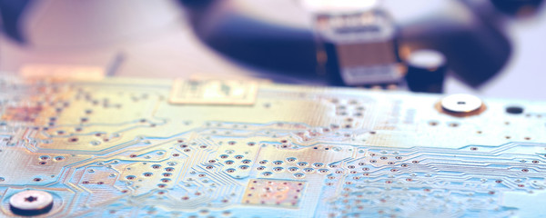 Green circuit board with microchips for electronic engineering. Panorama format.