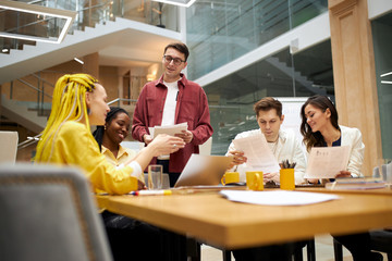 young business people sharing creative ideas , plans, designers discussing project, text, report indoors. creativity concept