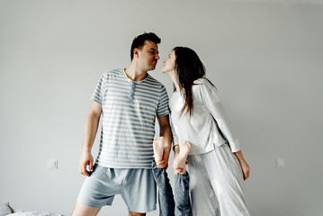 portrait of a happy family in the morning,family in pajamas,family photo,happy young family posing...