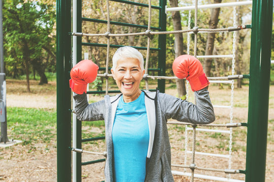 Healthy Senior Woman With Boxing Glove At Outdoor Fitness Park
