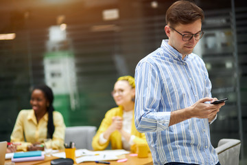 Group of business people working while their male colleague cheating with documents, contract,...