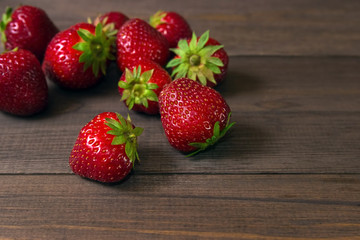 Ripe red strawberries on wooden table