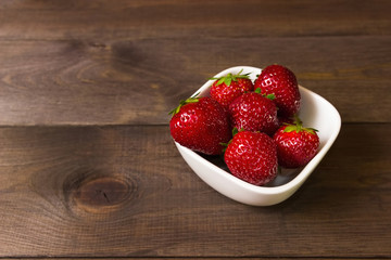 Ripe red strawberries on wooden table