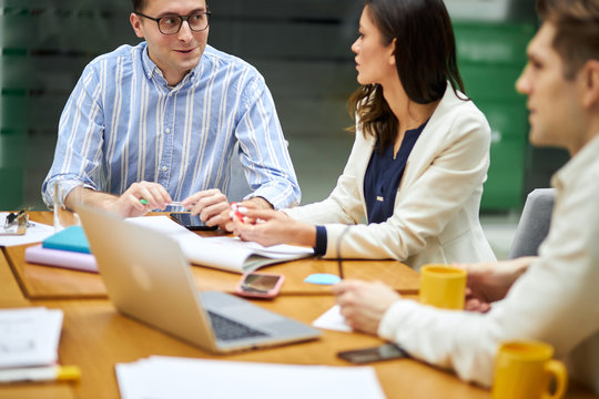 handsome cheerful man in striped shirt looking at awesome woman who is giving advice to him or recommend something . close up photo - Powered by Adobe