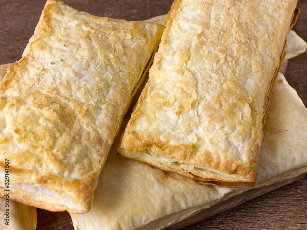 Wall mural closeup puff pastry cakes with crispy crust