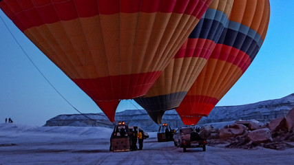 Hot air balloons preparing to fly at early morning in winter season in Cappadocia, Turkey