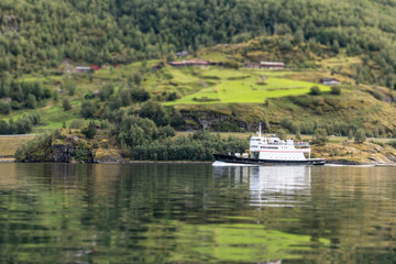 Fototapeta na wymiar Ship on water of norwegian fjord Aurlandsfjord