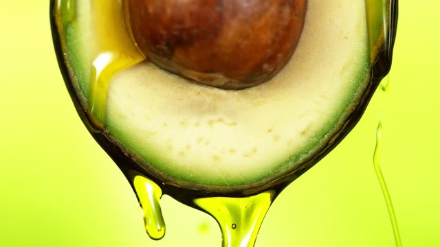 Super slow motion of splashing oil on avocado slice. Filmed on high speed cinema camera.