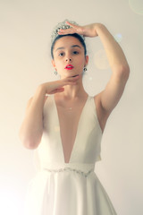 Beautiful bride.Close-up portrait of attractive fashion model teenager bride meekly looking at the camera. Studio shot.