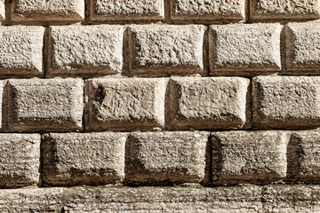 Fototapeta premium Ashlar (Bugnato in Italian), closeup of a wall made of big blocks of stones in Trento city, Trentino Alto Adige, Italy, Europe