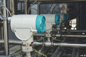 Measurement equipment installed on stainless steel pipes in industrial systems