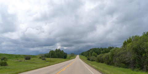 Road passing through rural countryside, Alberta Prairies, Alberta, Canada