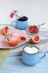 Natural ice cream, grapefruit, basil on a wooden table, tasty and healthy dessert, seasonal food