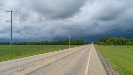 Road passing through rural area, Alberta Prairies, Alberta, Canada - 329143328