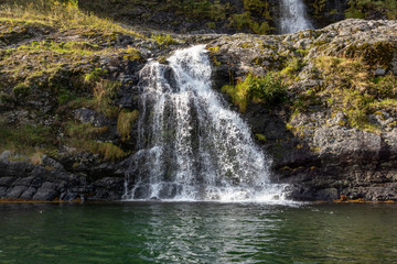 Waterfall falling in norwegian fjord Aurlandsfjord
