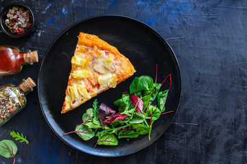 slice pizza and salad leaves in a plate on the table (tasty snack) menu concept background. top view. copy space for text