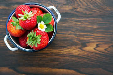 Macro shot on strawberries over wooden background.