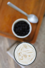 Taiwan iced milk tea fresh drink served with bubble boba sweet drink and boba refill in white small bowl 