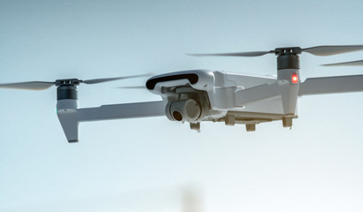 Quadrocopter drone hangs in the air. Shooting photos and videos from a height. Modern technologies...