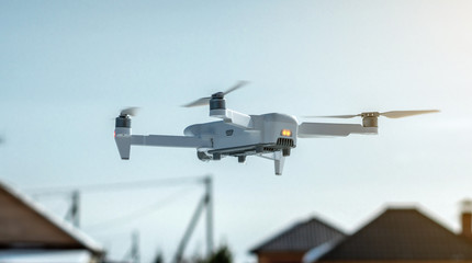 Quadrocopter drone hangs in the air. Shooting photos and videos from a height. Modern technologies of unmanned vehicles